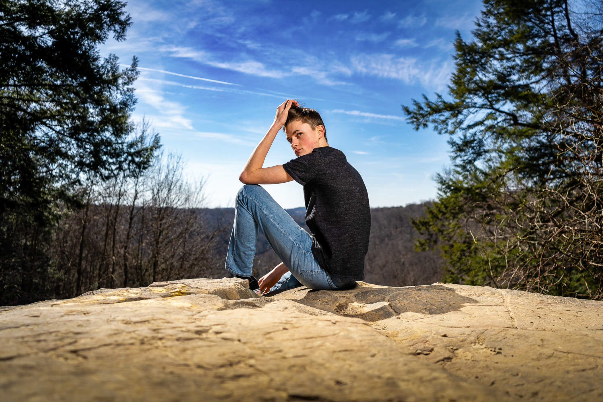 Portrait of a senior on top of cleland rock, a part of McConnell's Mill State Park, a senior portrait location near Pittsburgh PA